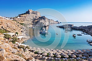 St. PaulÂ´s bay with boats, Lindos acropolis in background Rhod