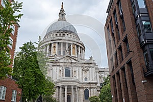 St Pauls Cathedral London, cloudy sky above, stunning green trees.