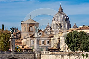 St. Peter`s basilica dome in Vatican seen from Tiber river embankment, Rome, Italy