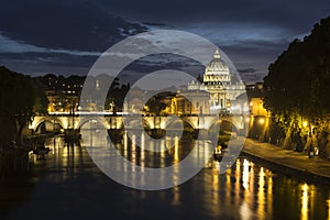 St. Peter`s Basilica and Ponte Sant angelo at dusk in vatican ci