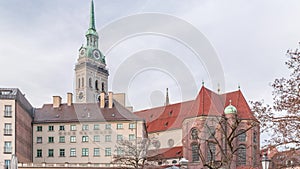 St. Peter's Church Peterskirche clock tower along Viktualienmarkt market street timelapse in Munich, Bavaria photo