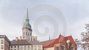 St. Peter's Church Peterskirche clock tower along Viktualienmarkt market street timelapse in Munich, Bavaria photo