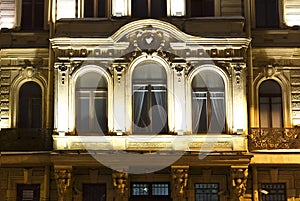 St. Petersburg facade of the historical building in Baroque style, balcony with Windows, night lighting