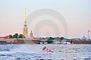 The man on the jet ski quickly floats on the Neva river on the b