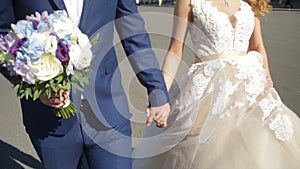 St Petersburg, Russia Bride and groom walking along. the bride and groom walk on the square near the winter Palace and