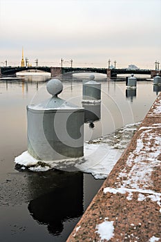 St. Petersburg, Russia, February 2020. Mooring posts for ships on the background of the Palace Bridge.