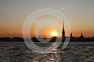 St. Petersburg, Russia, July 2022: the silhouette of the Peter and Paul Fortress at sunset, view from the Neva River