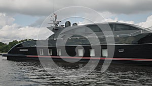 ST. PETERSBURG, RUSSIA - JUNE 11, 2023 : Luxury modern black yacht moored on the shores of the Neva Canal in St