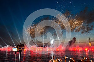 ST. PETERSBURG, RUSSIA - JUNE, 2018: People making photos of fireworks over Neva river at alumni celebration Scarlet sails