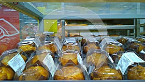 Hot fresh delicious cupcake in plastic wrap on supermarket shelf. Natural bakery products. Self-service basis. Concept of problem