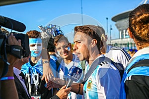 St. Petersburg, Russia - June 26, 2018: Journalist interviewing sport fans of Argentina national football team.