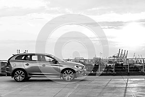 A modern luxury swedish car Volvo XC60 R-Design Polestar Edition on the roof of the building. Black and white