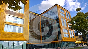 Orange and glass exterior of building. Modern architecture. Skyscraper geometry. Business office park. Urban real estate.