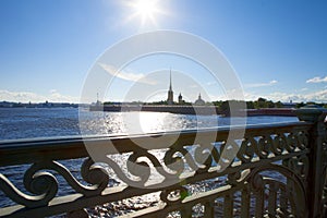 , St. Petersburg, Troitsky Bridge, view of the Neva and the Peter and Paul Fortress, the rays through the iron fence.