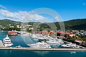 St.Thomas, British virgin island - January 13, 2016: yachts moored at sea pier on mountain landscape. Sea port and town on sunny b