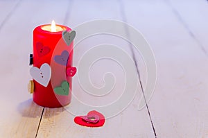 St. Valentine`s day burning candl on wooden table