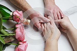 St. Valentine`s Day concept.Romantic dinner of old married couple.Closeup shot of hands