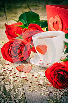 St Valentine's setting with coffee cup and red roses