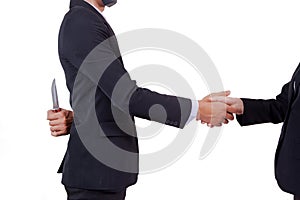 Stab back,two business men making a deal but hiding knives photo