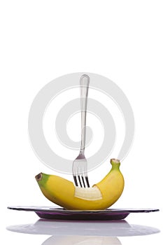 Stab banana with fork