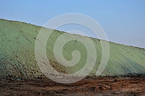 Stabilization of slopes by hydro sowing. a mixture of wood pulp and green grass seed is sprayed from the tank directly onto the ba