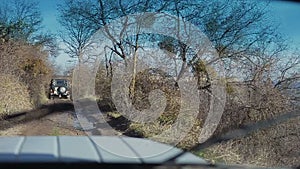 Stabilized camera is inside a jeep climbing up a mountain. Extreme auto tourism. View on mountains from an off road car.