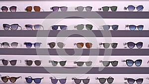 Stabilized video of shelf with sunglasses. Camera slowly and smoothly moves away from the glasses showing the scale