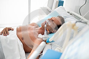 Middle aged man sleeping in hospital room after surgery photo