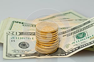 Stack of $20 dollar bills with gold coins