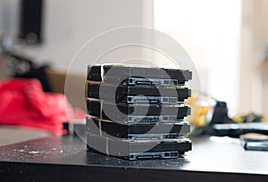 A stack of 3,5 inches SATA hard drives on a table