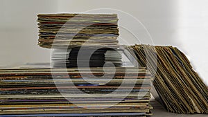 Stack of 45 and 33 rpm vinyl records arranged in a vertical stack.