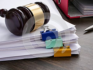 A stack of accounting papers and gavel. Financial white-collar crime and embezzlement. photo