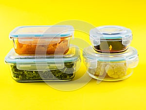 Stack of airtight glass containers with cooked food