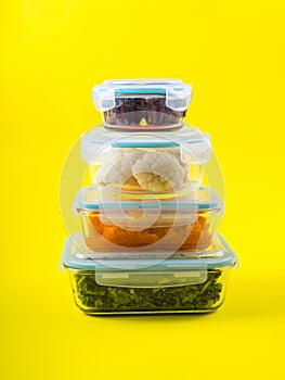 Stack of airtight glass containers with cooked food