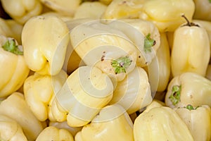 Stack of Albino bullmose peppers on a market stall