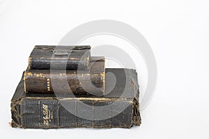 Stack of Antique Bibles on White Background