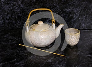 Stack of antique ceramic cups, teapot on a white background.vintage