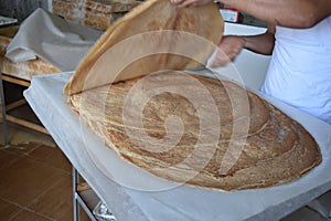 A stack of arabic bread called Markook in lebanon, juste after being cooked on a convex iron plate.