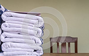 Stack of bath towels on wooden table