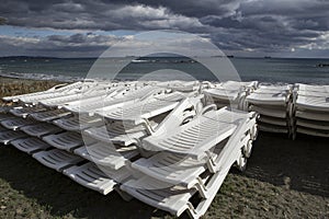 A stack of beach lounges out of season.