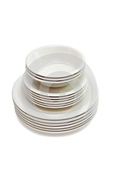 Stack beige dinner plates, soup plates and saucers