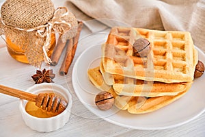 Stack of Belgian waffles on a white plate