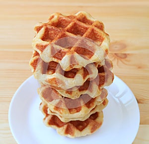 Stack Belgian Waffles on White Plate Served on Wooden Table