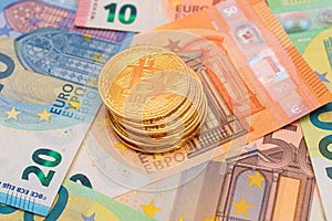 A Stack of Bitcoin Coins on the Euro Banknotes