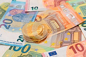 A Stack of Bitcoin Coins on the Euro Banknotes