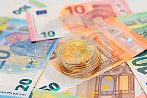 A Stack of Bitcoin Coins on the Euro Banknotes