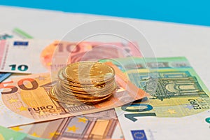 A Stack of Bitcoin Coins on the Euro Banknotes