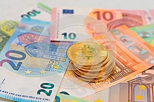A Stack of Bitcoin Coins on the Euro Banknotes