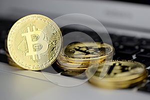 Stack of Bitcoin coins on laptop keyboard. Cryptocurrency. Selective focus