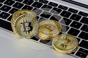 Stack of Bitcoin coins on laptop keyboard. Cryptocurrency. Selective focus